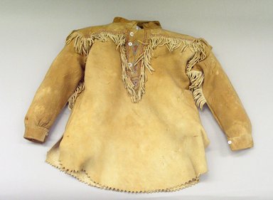 Possibly Blackfoot. <em>Boy's Shirt with Triangular Inset and Stylized Leaf Design</em>, 1920-1940. Buckskin, beads, plastic buttons, cotton thread, 15 x 22 in (38 x 56 cm). Brooklyn Museum, Bequest of W.S. Morton Mead, 32.2099.32577. Creative Commons-BY (Photo: Brooklyn Museum, CUR.32.2099.32577_view1.jpg)