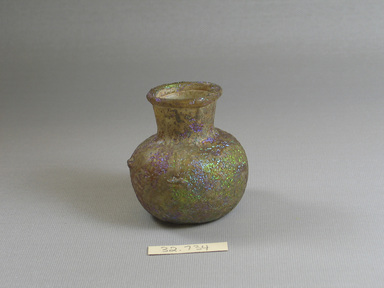 Roman. <em>Small Squat Bottle</em>, 4th-9th century C.E. Glass, 2 1/2 x Diam. 2 3/8 in. (6.4 x 6 cm). Brooklyn Museum, Gift of the executors of the Estate of Colonel Michael Friedsam, 32.734. Creative Commons-BY (Photo: Brooklyn Museum, CUR.32.734.jpg)