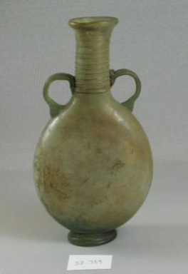 Roman. <em>Lentoid Flask</em>, 1st-5th century C.E. Glass, 6 7/8 x 1 7/8 x 1 1/2 x 3 3/4 in. (17.5 x 4.8 x 3.8 x 9.6 cm). Brooklyn Museum, Gift of the executors of the Estate of Colonel Michael Friedsam, 32.739. Creative Commons-BY (Photo: Brooklyn Museum, CUR.32.739_view1.jpg)