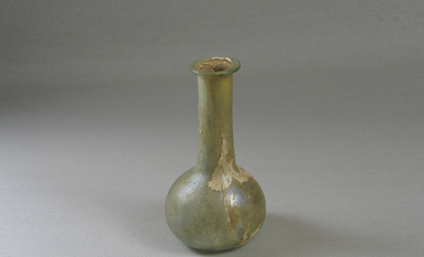 Roman. <em>Bottle</em>, 1st-2nd century C.E. Glass, 3 1/2 x greatest diam. 1 7/8 in. (8.9 x 4.8 cm). Brooklyn Museum, Gift of the executors of the Estate of Colonel Michael Friedsam, 32.743. Creative Commons-BY (Photo: Brooklyn Museum, CUR.32.743_view1.jpg)