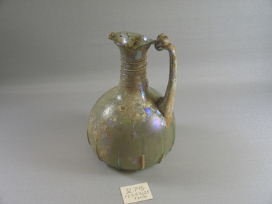 Roman. <em>Jug</em>, 1st-5th century C.E. Glass, 6 5/16 x greatest diam. 4 1/8 in. (16 x 10.4 cm)  . Brooklyn Museum, Gift of the executors of the Estate of Colonel Michael Friedsam, 32.745. Creative Commons-BY (Photo: Brooklyn Museum, CUR.32.745_view1.jpg)