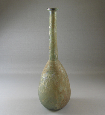 Roman. <em>Bottle</em>, 1st-2nd century C.E. Glass, Greatest diam. 3 1/16 x 9 3/8 in. (7.8 x 23.8 cm). Brooklyn Museum, Gift of the executors of the Estate of Colonel Michael Friedsam, 32.747. Creative Commons-BY (Photo: Brooklyn Museum, CUR.32.747_view1.jpg)