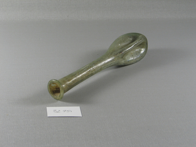 Roman. <em>Bottle with Folded Body Decoration</em>, 1st-6th century C.E. Glass, 7 3/8 x 1 7/16 x 1 3/8 in. (18.8 x 3.7 x 3.5 cm). Brooklyn Museum, Gift of the executors of the Estate of Colonel Michael Friedsam, 32.751. Creative Commons-BY (Photo: Brooklyn Museum, CUR.32.751_view1.jpg)
