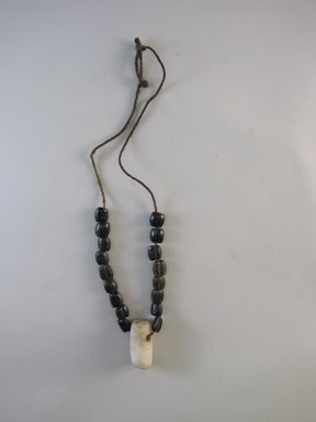 Tukano. <em>Necklace with Quartz Pendant</em>, early 20th century. Plant fiber, seeds, and quartz, 2 3/4 × 3/4 × 12 5/16 in. (7 × 1.9 × 31.3 cm). Brooklyn Museum, Museum Expedition 1933, Purchased with funds given by Jesse Metcalf, 33.641. Creative Commons-BY (Photo: Brooklyn Museum, CUR.33.641.jpg)