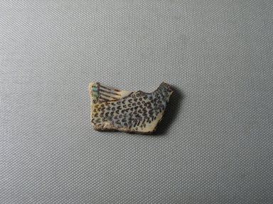  <em>Fragment of Bird</em>, ca. 1352–1336 B.C.E. Faience, 1 1/8 × 1 3/4 × 1/4 in. (2.8 × 4.5 × 0.7 cm). Brooklyn Museum, Gift of the Egypt Exploration Society, 33.689a. Creative Commons-BY (Photo: , CUR.33.689a_view01.jpg)
