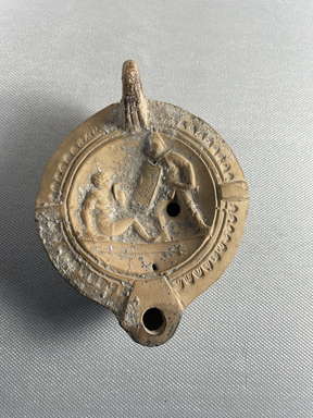 Roman. <em>Fictile Lamp</em>, 2nd century C.E. Clay, 1 3/4 × 3 5/16 × 4 3/16 in. (4.5 × 8.4 × 10.7 cm). Brooklyn Museum, Charles Edwin Wilbour Fund, 34.1211. Creative Commons-BY (Photo: Brooklyn Museum, CUR.34.1211_view01.jpeg)