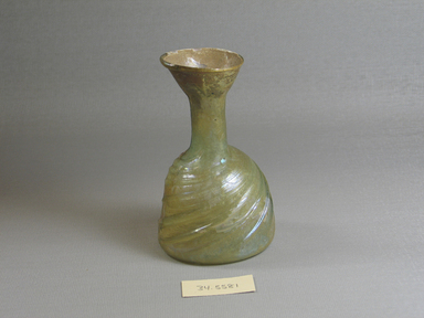 Roman. <em>Bottle</em>, 1st-5th century C.E. Glass, 4 5/16 x Diam. 2 5/8 in. (11 x 6.7 cm). Brooklyn Museum, Brooklyn Museum Collection, 34.5581. Creative Commons-BY (Photo: Brooklyn Museum, CUR.34.5581.jpg)