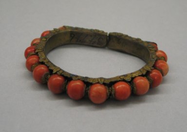  <em>Bracelet</em>, 19th century. gilded brass, coral, kingfisher feather, 2 15/16 x 3/8 x 3 9/16 in. (7.5 x 1 x 9 cm). Brooklyn Museum, Brooklyn Museum Collection, 34.945. Creative Commons-BY (Photo: Brooklyn Museum, CUR.34.945_view1.jpg)