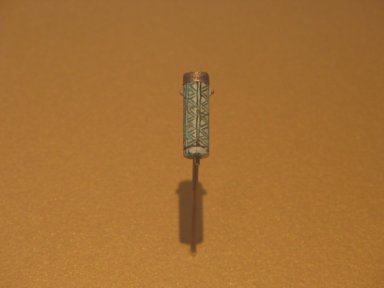  <em>Cylinder Bead with Geometric Design</em>, ca. 1938–1700 B.C.E. Steatite, glaze, silver, 7/8 x 1/4 in. (2.2 x 0.6 cm). Brooklyn Museum, Gift of Theodora Wilbour from the collection of her father, Charles Edwin Wilbour, 35.1184. Creative Commons-BY (Photo: Brooklyn Museum, CUR.35.1184_erg2.jpg)