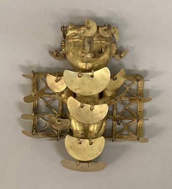 Quimbaya. <em>Pendant of Seated Woman</em>, 500-700. Alloy of gold and copper (tumbaga), 5 1/8 × 4 1/2 × 1 1/8 in. (13 × 11.4 × 2.9 cm). Brooklyn Museum, Alfred W. Jenkins Fund, 35.196. Creative Commons-BY (Photo: Brooklyn Museum, CUR.35.196.jpg)