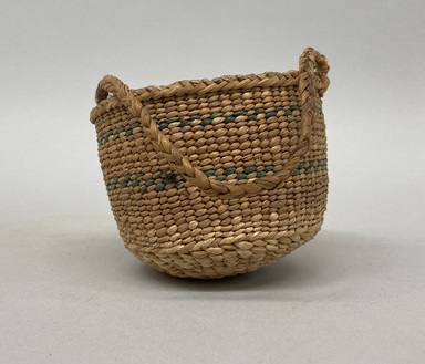Northwest Coast. <em>Basket with Braided Handle</em>, early 20th century. Plant fiber, sweetgrass, 2 15/16 × 3 7/8 × 3 3/4 in. (7.5 × 9.8 × 9.5 cm). Brooklyn Museum, Gift of Edith E. Dexter, 36.110. Creative Commons-BY (Photo: Brooklyn Museum, CUR.36.110_overall.jpg)