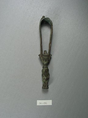  <em>Small Sistrum</em>, 305–30 B.C.E. Bronze, 5 11/16 x 7/8 x 13/16 in. (14.5 x 2.3 x 2.1 cm). Brooklyn Museum, Charles Edwin Wilbour Fund, 36.135. Creative Commons-BY (Photo: Brooklyn Museum, CUR.36.135_view1.jpg)