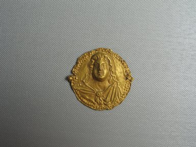 Byzantine. <em>Impressed face</em>, 350 C.E. Gold, 1 15/16 x 1/4 x 2 in. (5 x 0.6 x 5.1 cm). Brooklyn Museum, Frank L. Babbott Fund and Henry L. Batterman Fund, 36.159a. Creative Commons-BY (Photo: Brooklyn Museum, CUR.36.159a_view01.jpg)