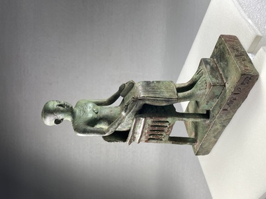  <em>Statuette of Imhotep</em>, 381-30 B.C.E. Coppery alloy, 6 15/16 × 2 3/16 × 4 5/8 in. (17.7 × 5.5 × 11.7 cm). Brooklyn Museum, Charles Edwin Wilbour Fund, 36.623. Creative Commons-BY (Photo: Brooklyn Museum, CUR.36.623_view01.jpg)