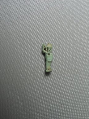  <em>Amun-Min Amulet</em>, 664-343 B.C.E. Faience, 1 1/16 x 3/8 x 5/16 in. (2.7 x 1 x 0.8 cm). Brooklyn Museum, Charles Edwin Wilbour Fund, 37.1036E. Creative Commons-BY (Photo: Brooklyn Museum, CUR.37.1036E_view01.jpg)