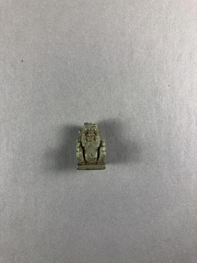  <em>Bes Amulet</em>, 334–332 B.C.E. Faience, 13/16 × 1/2 × 3/8 in. (2 × 1.3 × 1 cm). Brooklyn Museum, Charles Edwin Wilbour Fund, 37.1098E. Creative Commons-BY (Photo: , CUR.37.1098E_view01.jpg)