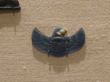  <em>Scarab with Falcon Head</em>, ca. 525-30 B.C.E. Glass, 15/16 x 1 11/16 x 3/16 in. (2.4 x 4.3 x 0.4 cm). Brooklyn Museum, Charles Edwin Wilbour Fund, 37.1134E. Creative Commons-BY (Photo: Brooklyn Museum, CUR.37.1134E_wwg8.jpg)