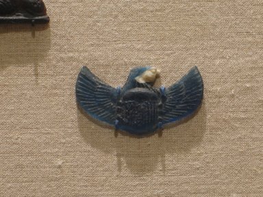  <em>Scarab with Falcon Head</em>, ca. 525–30 B.C.E. Glass, 15/16 x 1 11/16 x 3/16 in. (2.4 x 4.3 x 0.4 cm). Brooklyn Museum, Charles Edwin Wilbour Fund, 37.1134E. Creative Commons-BY (Photo: Brooklyn Museum, CUR.37.1134E_wwg8.jpg)