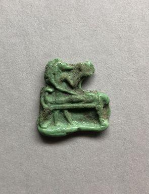  <em>Inlay or Amulet Representing Anubis</em>, 305–30 B.C.E. Glass, 1 × 1 × 3/16 in. (2.5 × 2.5 × 0.4 cm). Brooklyn Museum, Charles Edwin Wilbour Fund, 37.1146E. Creative Commons-BY (Photo: , CUR.37.1146E_view01.JPG)