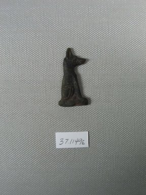  <em>Inlay of a Seated Jackal</em>, 525-30 B.C.E. Glass, 1 9/16 x 13/16 x 3/16 in. (4 x 2 x 0.4 cm). Brooklyn Museum, Charles Edwin Wilbour Fund, 37.1149E. Creative Commons-BY (Photo: Brooklyn Museum, CUR.37.1149E_view1.jpg)