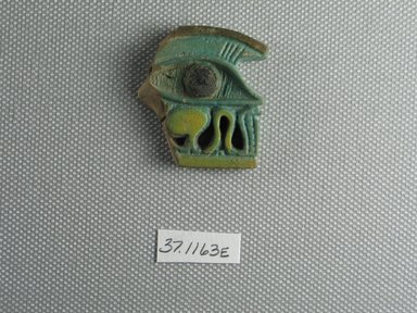  <em>Fragmentary Wadjet-eye Amulet</em>, ca. 838–712 B.C.E. Faience, 1 3/8 x 1/4 x 1 1/4 in. (3.5 x 0.7 x 3.2 cm). Brooklyn Museum, Charles Edwin Wilbour Fund, 37.1163E. Creative Commons-BY (Photo: Brooklyn Museum, CUR.37.1163E_view1.jpg)