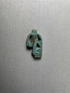  <em>Amulet of the Deity Heh Holding Signs for Millions of Years</em>, ca. 945&ndash;718 B.C.E. Faience, 7/8 &times; 1/4 &times; 1 9/16 in. (2.2 &times; 0.6 &times; 3.9 cm). Brooklyn Museum, Charles Edwin Wilbour Fund, 37.1169E. Creative Commons-BY (Photo: Brooklyn Museum, CUR.37.1169E_front.JPG)