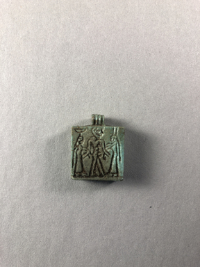  <em>Amulet in the Form of a Plaque</em>, ca. 664-525 B.C.E. Faience, 7/8 × 11/16 × 1/4 in. (2.2 × 1.7 × 0.7 cm). Brooklyn Museum, Charles Edwin Wilbour Fund, 37.1205E. Creative Commons-BY (Photo: , CUR.37.1205E_view01.jpg)