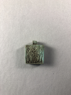  <em>Amulet in the Form of a Plaque</em>, ca. 664–525 B.C.E. Faience, 7/8 × 11/16 × 1/4 in. (2.2 × 1.7 × 0.7 cm). Brooklyn Museum, Charles Edwin Wilbour Fund, 37.1205E. Creative Commons-BY (Photo: , CUR.37.1205E_view01.jpg)