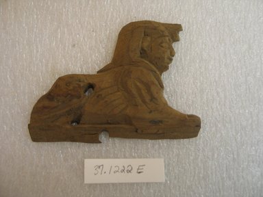  <em>Small Sphinx, Probably Not Ancient Egyptian</em>. Wood, 2 15/16 x 7/16 x 3 15/16 in. (7.5 x 1.1 x 10 cm). Brooklyn Museum, Charles Edwin Wilbour Fund, 37.1222E. Creative Commons-BY (Photo: Brooklyn Museum, CUR.37.1222E_view1.jpg)