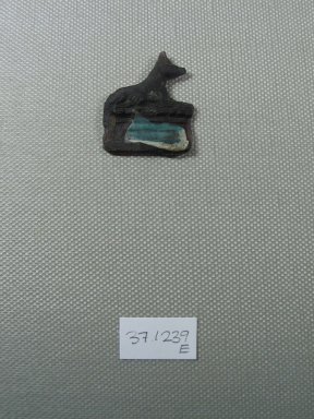  <em>Inlay Representing a Recumbent Jackal or Shrine</em>, 525-30 B.C.E. Glass, 1 1/16 x 1/8 x 1 1/4 in. (2.7 x 0.3 x 3.2 cm). Brooklyn Museum, Charles Edwin Wilbour Fund, 37.1239E. Creative Commons-BY (Photo: Brooklyn Museum, CUR.37.1239E_view1.jpg)