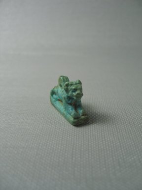  <em>Amulet Representing a Recumbent Lion</em>, 664–332 B.C.E. Faience, 3/4 x 1 3/16 in. (1.9 x 3 cm). Brooklyn Museum, Charles Edwin Wilbour Fund, 37.1250E. Creative Commons-BY (Photo: Brooklyn Museum, CUR.37.1250E_View1.jpg)