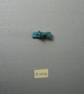  <em>Recumbent Lion Amulet</em>, 664–332 B.C.E. Faience, 9/16 x 5/16 x 7/8 in. (1.4 x 0.9 x 2.2 cm). Brooklyn Museum, Charles Edwin Wilbour Fund, 37.1251E. Creative Commons-BY (Photo: Brooklyn Museum, CUR.37.1251E_View4.jpg)