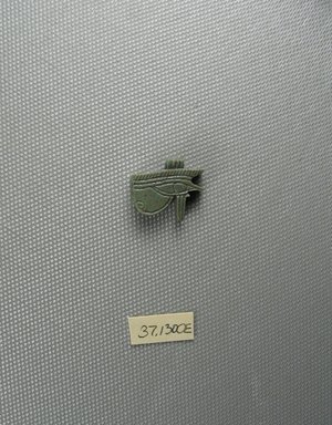  <em>Wadjet-eye Amulet</em>, 664–332 B.C.E. Faience, 11/16 x 3/16 x 13/16 in. (1.8 x 0.4 x 2 cm). Brooklyn Museum, Charles Edwin Wilbour Fund, 37.1300E. Creative Commons-BY (Photo: Brooklyn Museum, CUR.37.1300E_view1.jpg)
