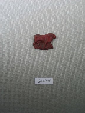  <em>Inlay in Form of Standing Ram</em>, 525-30 B.C.E. Glass, 1 x 1 3/8 x 1/8 in. (2.5 x 3.5 x 0.4 cm). Brooklyn Museum, Charles Edwin Wilbour Fund, 37.1317E. Creative Commons-BY (Photo: Brooklyn Museum, CUR.37.1317E_view1.jpg)