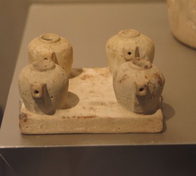  <em>Four Model Vessels on Common Base</em>, ca. 1539–1075 B.C.E. Limestone, 1 9/16 x 3 1/4 x 3 1/8 in. (4 x 8.3 x 8 cm). Brooklyn Museum, Charles Edwin Wilbour Fund, 37.1388E. Creative Commons-BY (Photo: Brooklyn Museum, CUR.37.1388E_erg456.jpg)