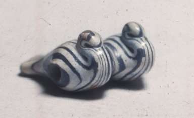  <em>Bead in the Form of Two Ducks</em>, ca. 1390-1352 B.C.E., or later. Glass, 5/16 × 5/8 × 11/16 in. (0.8 × 1.6 × 1.8 cm). Brooklyn Museum, Charles Edwin Wilbour Fund, 37.1444E. Creative Commons-BY (Photo: Brooklyn Museum, CUR.37.1444E_view1.jpg)