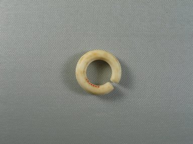  <em>Penannular Earring</em>, ca. 1539–1190 B.C.E. Egyptian alabaster, 7/16 × Diam. 1 7/16 in. (1.1 × 3.7 cm). Brooklyn Museum, Charles Edwin Wilbour Fund, 37.1454E. Creative Commons-BY (Photo: Brooklyn Museum, CUR.37.1454E_view02.jpg)