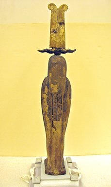  <em>Mummiform Figure of Osiris</em>, 664-332 B.C.E. Wood, stucco, pigment, linen, plant material, 27 15/16 x 3 9/16 x 6 5/16 in. (71 x 9 x 16 cm). Brooklyn Museum, Charles Edwin Wilbour Fund, 37.1480Ea-c. Creative Commons-BY (Photo: , CUR.37.1480Ea-c_view12.jpg)