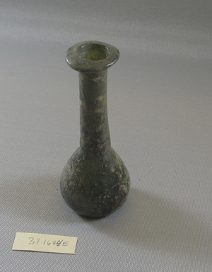  <em>Bottle</em>, 1st-3rd century C.E. Glass, Greatest Diam. 1 15/16 x 4 15/16 in. (5 x 12.5 cm). Brooklyn Museum, Charles Edwin Wilbour Fund, 37.1644E. Creative Commons-BY (Photo: Brooklyn Museum, CUR.37.1644E_view1.jpg)
