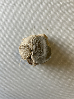  <em>Small Sealing Attached to Wad</em>. Mud, linen, Seal: 1 13/16 × 1 1/4 × 1 3/4 in. (4.6 × 3.1 × 4.4 cm). Brooklyn Museum, Charles Edwin Wilbour Fund, 37.1883E. Creative Commons-BY (Photo: Brooklyn Museum, CUR.37.1883E_view01.jpg)