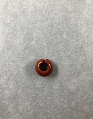 <em>Penannular Earring</em>. Red jasper, Diam. 1/4 × 9/16 in. (0.7 × 1.4 cm). Brooklyn Museum, Charles Edwin Wilbour Fund, 37.1962E. Creative Commons-BY (Photo: , CUR.37.1962E_view01.jpg)