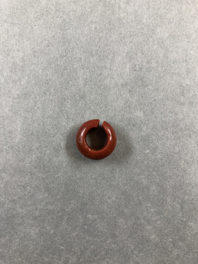  <em>Penannular Earring</em>. Red jasper, Diam. 1/4 × 9/16 in. (0.6 × 1.5 cm). Brooklyn Museum, Charles Edwin Wilbour Fund, 37.1963E. Creative Commons-BY (Photo: , CUR.37.1963E_view01.jpg)
