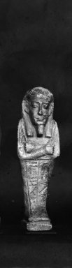  <em>Ushabti of Nesi-Kedwet</em>, 525-343 B.C.E. Faience, 4 3/16 x 1 1/4 in. (10.6 x 3.2 cm). Brooklyn Museum, Charles Edwin Wilbour Fund, 37.198E. Creative Commons-BY (Photo: Brooklyn Museum, CUR.37.198E_37.197E_NegGRPA_print_cropped_bw.jpg)