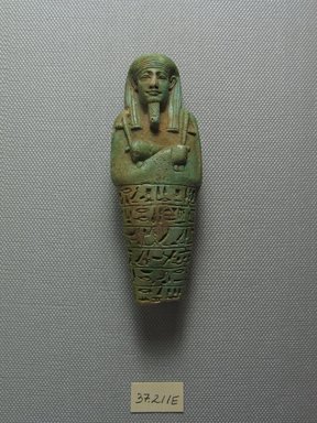  <em>Ushabti of the Head of Physician Psamtik-seneb</em>, 664-525 B.C.E. Faience, 3 15/16 x 1 3/8 in. (10 x 3.5 cm). Brooklyn Museum, Charles Edwin Wilbour Fund, 37.211E. Creative Commons-BY (Photo: Brooklyn Museum, CUR.37.211E_view1.jpg)