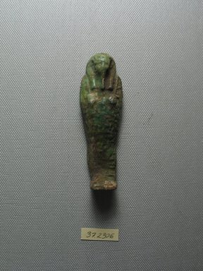  <em>Ushabti of Yuf-o</em>, 664-343 B.C.E. Faience, 3 9/16 x 1 1/16 x 11/16 in. (9 x 2.8 x 1.8 cm) . Brooklyn Museum, Charles Edwin Wilbour Fund, 37.230E. Creative Commons-BY (Photo: Brooklyn Museum, CUR.37.230E_view1.jpg)