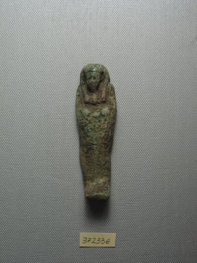  <em>Ushabti of Yuf-o</em>, 664-343 B.C.E. Faience, 3 1/4 x 7/8 x 1/2 in. (8.3 x 2.3 x 1.3 cm). Brooklyn Museum, Charles Edwin Wilbour Fund, 37.233E. Creative Commons-BY (Photo: Brooklyn Museum, CUR.37.233E_view1.jpg)