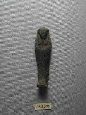  <em>Ushabti of Yuf-o</em>, 664-343 B.C.E. Faience, 3 1/4 x 1 x 13/16 in. (8.3 x 2.5 x 2 cm). Brooklyn Museum, Charles Edwin Wilbour Fund, 37.237E. Creative Commons-BY (Photo: Brooklyn Museum, CUR.37.237E_view1.jpg)