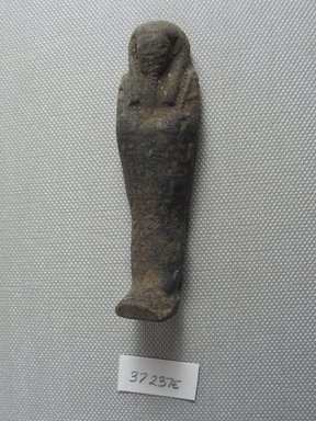  <em>Ushabti of Yuf-o</em>, 664-343 B.C.E. Faience, 3 1/4 x 1 x 13/16 in. (8.3 x 2.5 x 2 cm). Brooklyn Museum, Charles Edwin Wilbour Fund, 37.237E. Creative Commons-BY (Photo: Brooklyn Museum, CUR.37.237E_view2.jpg)