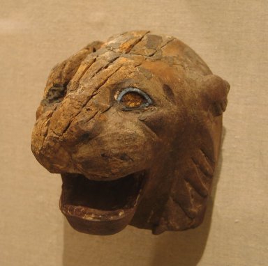  <em>Lion Head from a Chair or Throne</em>, 525-404 B.C.E. Wood, glass, 5 x 4 5/8 x 4 11/16 in. (12.7 x 11.8 x 11.9 cm). Brooklyn Museum, Charles Edwin Wilbour Fund, 37.261E. Creative Commons-BY (Photo: Brooklyn Museum, CUR.37.261E_wwg8.jpg)