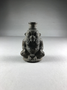  <em>Small Bottle in the Form of the God Bes</em>, 305-30 B.C.E. Terracotta, 3 1/16 × 2 1/16 × 1 5/8 in. (7.8 × 5.2 × 4.2 cm). Brooklyn Museum, Charles Edwin Wilbour Fund, 37.323E. Creative Commons-BY (Photo: , CUR.37.323E_view01.jpg)
